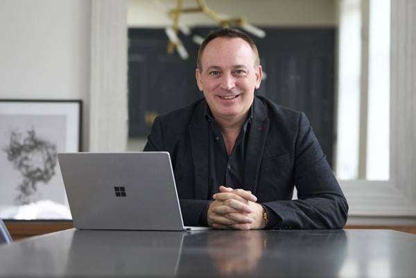 Jonathan Jay smiling in a bright office setting